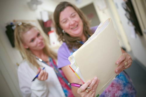 staff holding folders